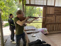 Poppy watching David shoot a pop gun